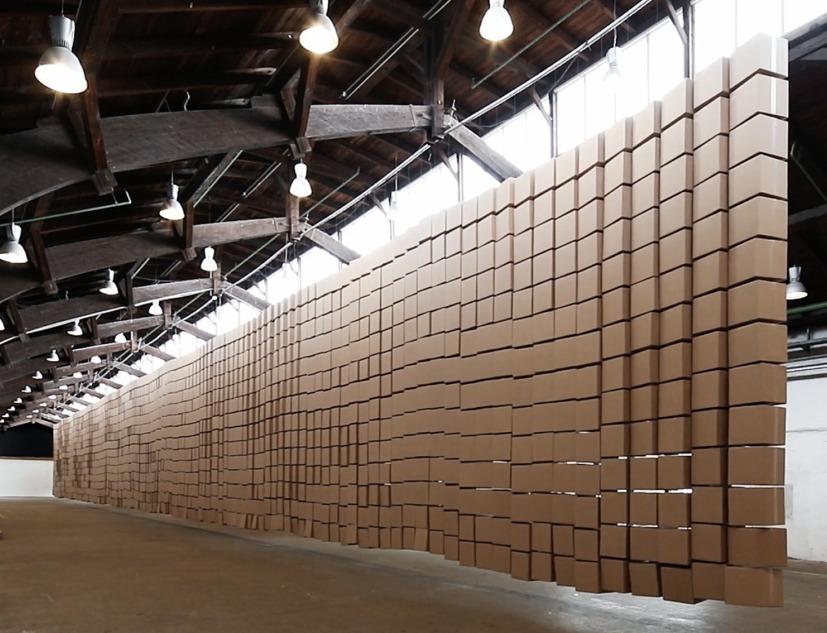 435 prepared dc-motors, 2030 cardboard boxes 35x35x35cm by Zimoun. Image courtesy of Zimoun