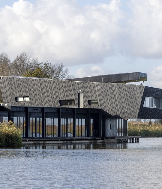 View from the water. Expansion of NBC de Oostvaarders by Woonwerk Architecten. Photograph by Luuk Kramer View from the water. Expansion of NBC de Oostvaarders by Woonwerk Architecten. Photograph by Luuk Kramer