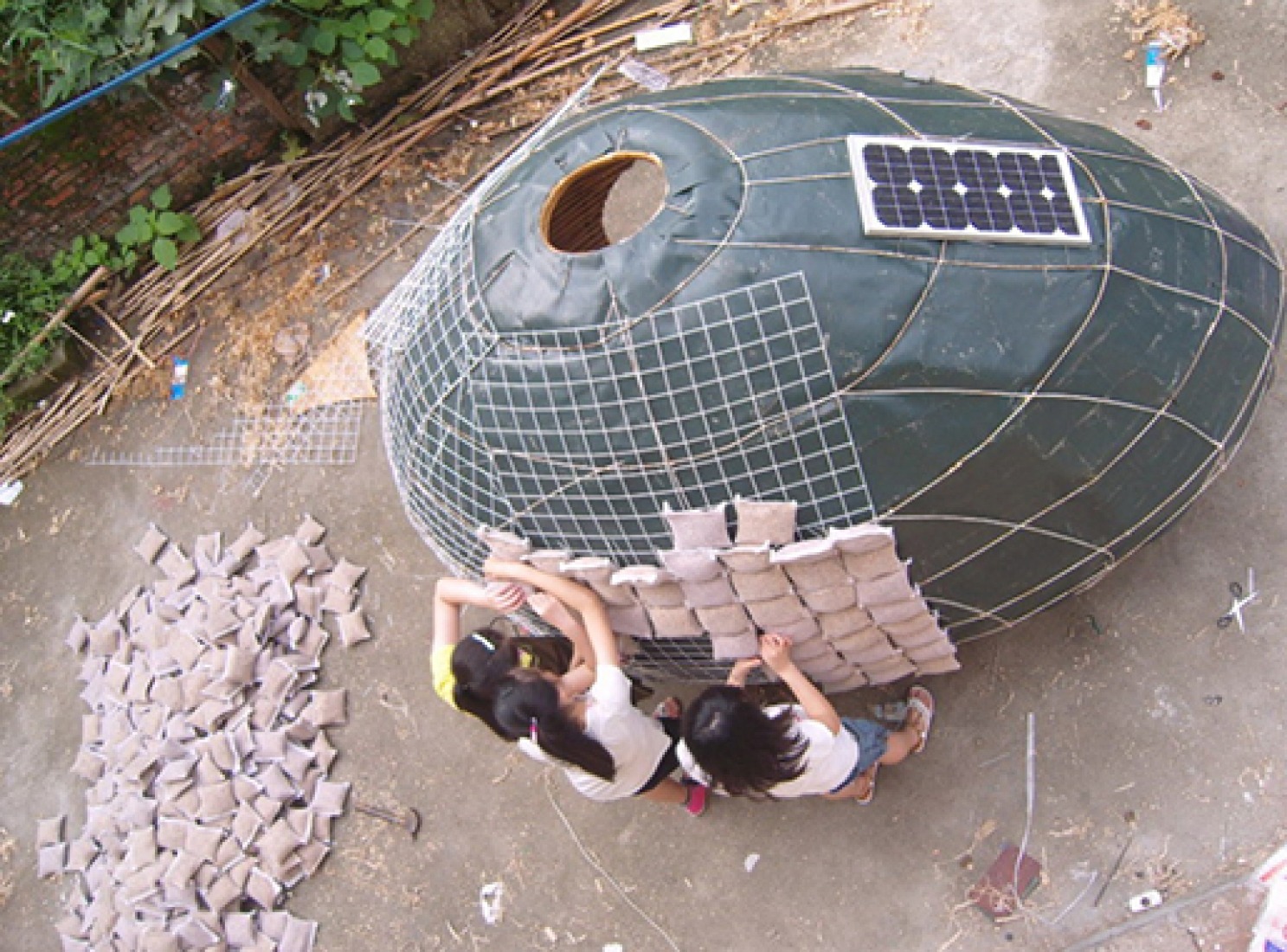 La capa exterior de la casa huevo esta realizada con unas bolsas que contienen gramineas.