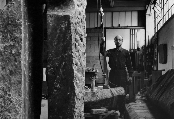 ​Isamu Noguchi in his 10th Street studio, Long Island City, 1966. Photograph by Kaz Inouye. The Noguchi Museum Archive. ©The Isamu Noguchi Foundation and Garden Museum, New York / Artists Rights Society (ARS).