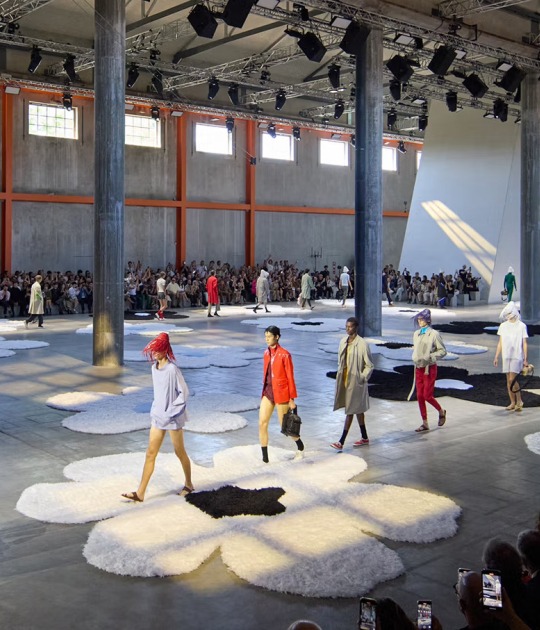 Prada’s show set at Milan Fashion Week S/S 2026, with the Deposito space at Fondazione Prada windows opened, allowing light in. Photograph courtesy of Prada Prada’s show set at Milan Fashion Week S/S 2026, with the Deposito space at Fondazione Prada windows opened, allowing light in. Photograph courtesy of Prada