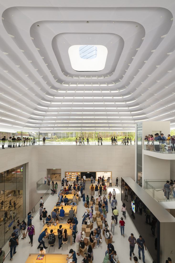 The store is laid out across three levels with a viewing deck at the top that directly connects with the edge of the park, bringing daylight and greenery into the store through the soaring interior. Apple store in Malaysia by Foster + Partners. Photograph by Nigel Young.